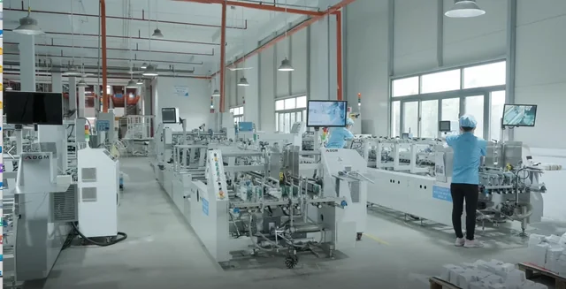 Packaging production floor with equipment and monitoring screens
