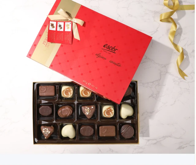 Red chocolate gift box with a gold-patterned lid and fitted chocolate compartments