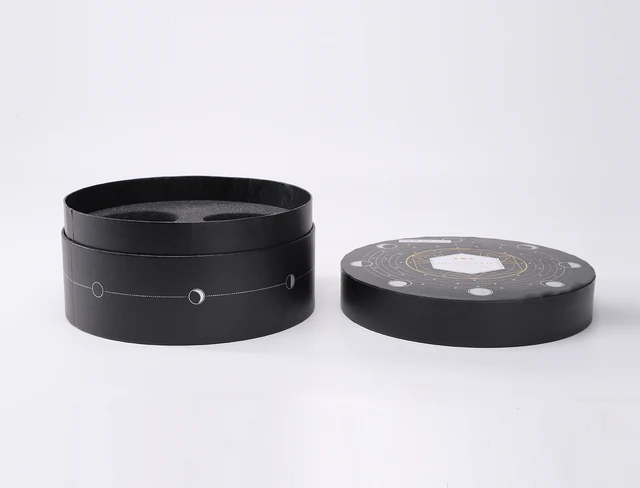 Open cylindrical paper tube box with its lid beside the body